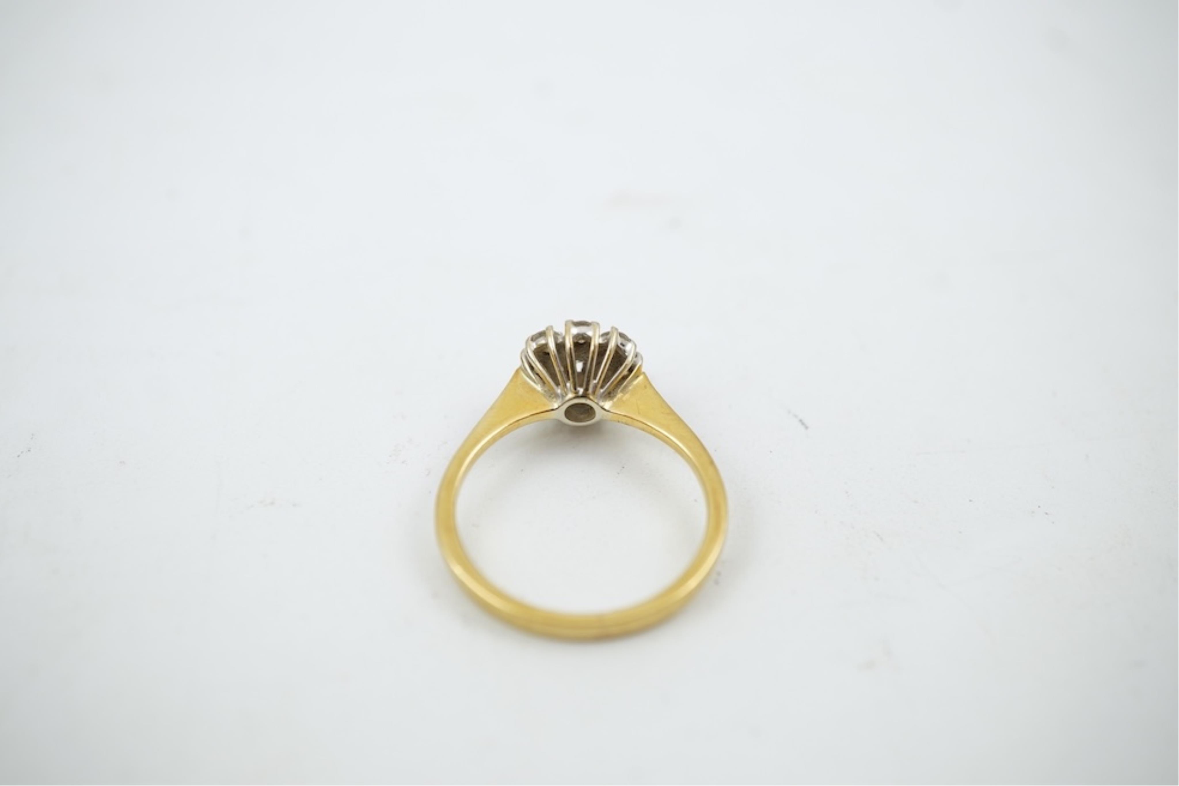 A modern 18ct gold and diamond set circular cluster ring, size M, gross weight 3.2 grams.